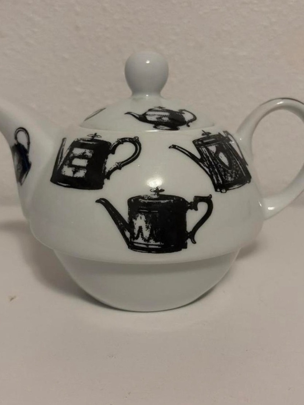 White Ceramic Teapot with Black Teapot Illustrations